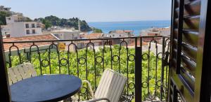 a table and chairs on a balcony with a view of the ocean at Apartments Prag in Ulcinj