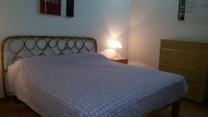 a bedroom with a bed and a dresser and a lamp at Case Susinna in Capaci