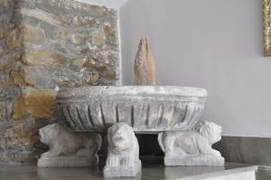 a stone fountain in front of a stone wall at Boutique Hotel Mamabels in Mojácar