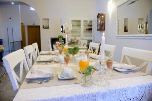 a dining room table with a white table cloth and glasses at Casa da Amendoeira in Castelo Rodrigo