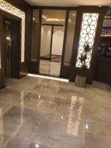 a lobby with a large tile floor and a door at Hotel Zayara in Riyadh