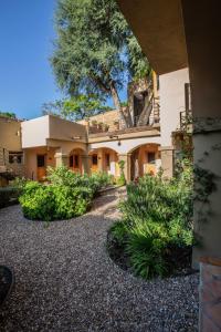 a large house with a courtyard with plants at Casa Naré Adults Only in San Miguel de Allende