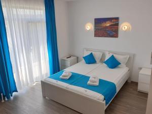 Postel nebo postele na pokoji v ubytování Techirghiol Blue