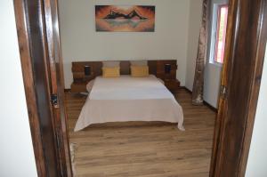A bed or beds in a room at Alojamento Rosário
