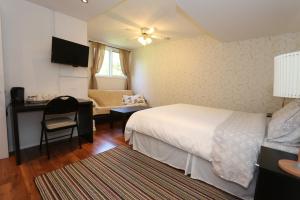 a bedroom with a bed and a desk and a chair at Cedar Drive Inn in Crysler