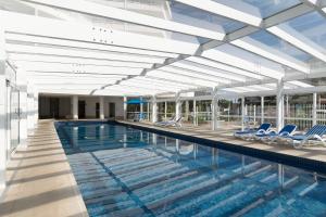 a large swimming pool with blue chairs at 19th Avenue on the Beach in Gold Coast