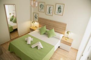a bedroom with a large bed with towels on it at Be Free Carboneras in Carboneras