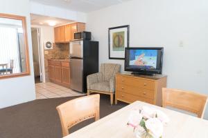 a kitchen with a television and a table with a dining room at Horizon Motor Inn in North Wildwood
