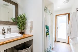 a bathroom with a sink and a mirror at Charming 1-Bedroom Home near Downtown Culver in Los Angeles +30 photos