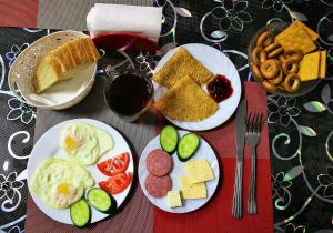 two plates of food on a table with cheese at Hotel Dauria in Listvyanka