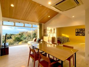 a living room with a table and a couch at La Krasse Angelroad in Tonosho