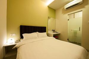 Postel nebo postele na pokoji v ubytování Seven Hotel