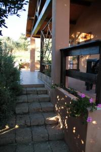 a pathway leading to a house with some flowers at Agriturismo San Mauro in Capalbio