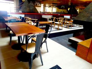 uma sala de jantar com mesas e cadeiras de madeira em El Colorado Ski depto In Out 2 ambientes em Farellones