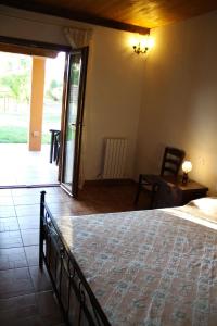 a bedroom with a bed and a table and a chair at Agriturismo San Mauro in Capalbio