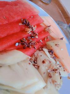 a plate with watermelon and other foods on it at Safsia homestay in Nusa Penida