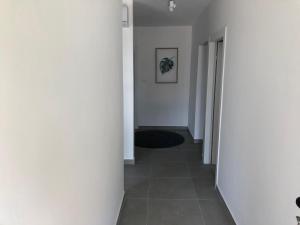 a hallway with white walls and a tile floor at Villa Lorenta Apartments in Primošten