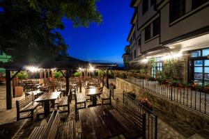 a restaurant with tables and chairs at night at Hotel Manastir Sv. Joakim Osogovski in Kriva Palanka