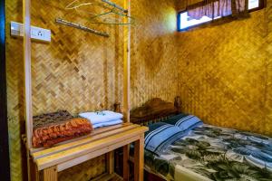 a room with two beds in a small room at Thoms Beach Homestay in Alleppey