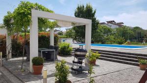a backyard with a grill and a swimming pool at Apartments Kovacic in Malinska