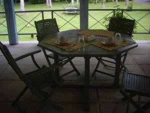 una mesa con 2 sillas y una mesa con platos y servilletas en La Grange des Marettes, en Cléres