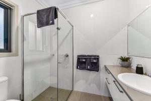 a bathroom with a glass shower and a sink at Accommodation on Lansell 2 in Mount Gambier