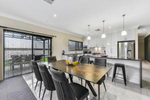 a kitchen and dining room with a table and chairs at Accommodation on Lansell 2 in Mount Gambier