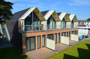a row of houses with balconies on a deck at Beach House Seebude in Büsum