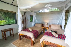 Säng eller sängar i ett rum på Caprivi Mutoya Lodge and Campsite