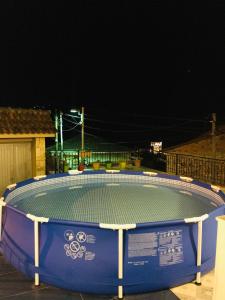 a large swimming pool in a yard at night at Guesthouse BellaVista in Berat