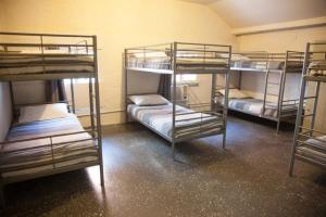 a bunk bed with two bunk beds in a room at Fremantle Hostel in Fremantle