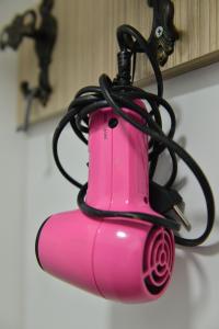 a pink lamp with a black cord on top of it at DELUXE Apartmani Lola - Vrnjačka banja in Vrnjačka Banja