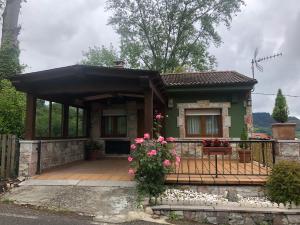 a small house with a porch and a fence at La Mermellina, 22 in Arriondas +14 photos