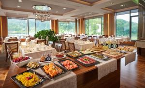 a buffet line with food on a table in a restaurant at Atlantida Boutique Hotel in Rogaška Slatina