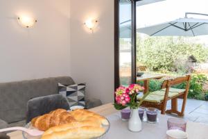 a table with a plate of bread on top of it at Apartment Adrijana in Vrbnik +20 photos