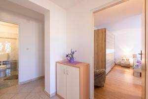 a living room with a refrigerator and a bedroom at Apartment Adrijana in Vrbnik