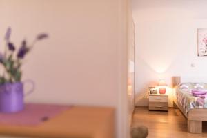a bedroom with a bed and a table with a potted plant at Apartment Adrijana in Vrbnik