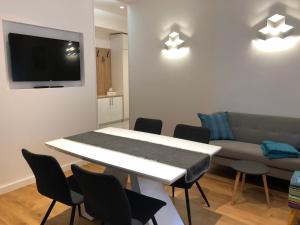 a living room with a table and a couch at Tempus Apartment in Split