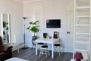 a living room with a white desk and chairs at Appartement LUXE et PRESTIGE proche Thermes, Parcs, Opéra in Vichy