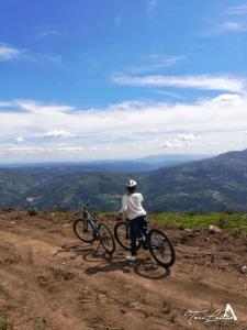 a person standing on a hill with two bikes at Casa Celeste in Castro Daire