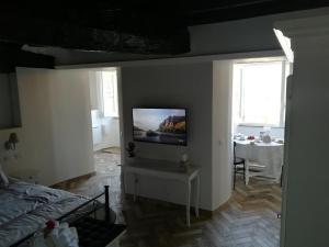 a living room with a television on a wall at Holiday Homes - mini spa - Nemi (Roma) in Nemi