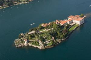 an island in the water with a mansion on it at Nel cuore di Stresa by Stresahome - Centro storico in Stresa