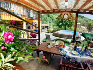 een tafel en stoelen op een patio met een zwembad bij Castelvecchio Family Retreat in San Marcello Pistoiese +32 foto's