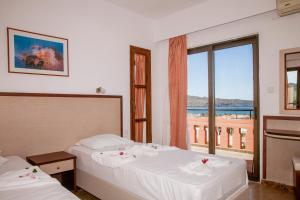 a hotel room with two beds and a window at Ekavi Apartments in Agia Marina Nea Kydonias +49 photos