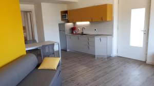 a small kitchen with a sink and a table at appartamentsandreis in Malcesine