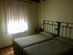 Tempat tidur dalam kamar di Hospedaje Casa Amalia