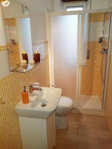 a bathroom with a toilet and a sink and a shower at Driade B&B in Milazzo