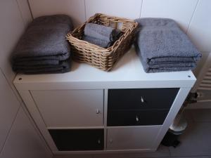 a laundry room with towels and baskets on a shelf at Komplette Unterkunft - Troisdorf - Rotter See 60m² in Troisdorf