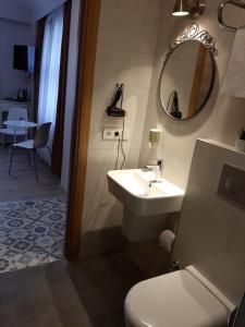 a bathroom with a sink and a toilet and a mirror at Hotel Nova in Istanbul