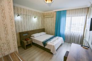 Postel nebo postele na pokoji v ubytování Cagdas Hotel